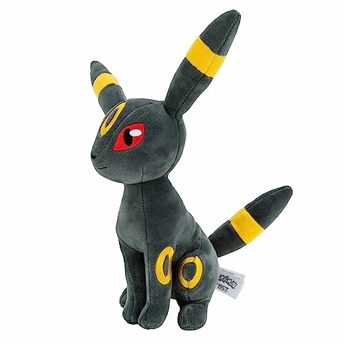 Zachte knuffel in de vorm van een donkergrijze Pokémon met gele ringen.